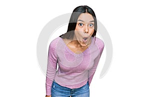 Young hispanic girl wearing casual clothes afraid and shocked with surprise expression, fear and excited face