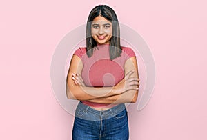 Young hispanic girl wearing casual t shirt happy face smiling with crossed arms looking at the camera