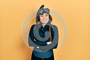 Young hispanic girl wearing diver neoprene uniform happy face smiling with crossed arms looking at the camera