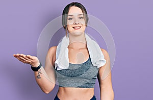 Young hispanic girl wearing sportswear and towel smiling cheerful with open arms as friendly welcome, positive and confident