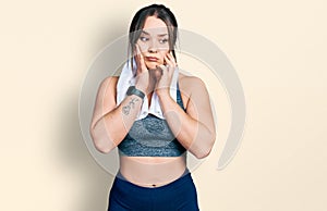 Young hispanic girl wearing sportswear and towel tired hands covering face, depression and sadness, upset and irritated for