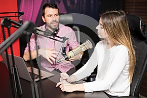 Radio hosts moderating a live show at station