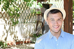 Young Hispanic male smiling outside with copy space