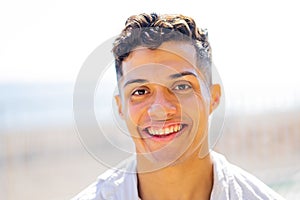 Young hispanic man 20- 25 years old smiling happy looking to the camera outdoors