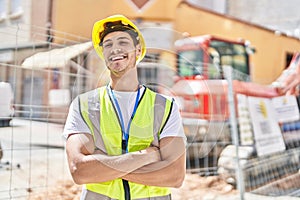 Young hispanic man architect smiling confident standing with arms crossed gesture at park