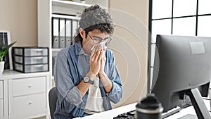 Young hispanic man business worker being sick using napkin at office