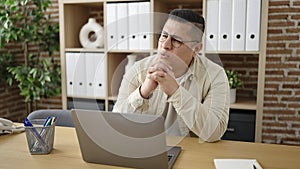 Young hispanic man business worker suffering for backache at office