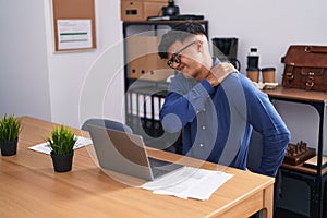 Young hispanic man business worker suffering for backache working at office