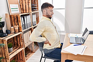 Young hispanic man business worker suffering for backache working at office