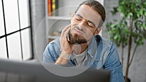 Young hispanic man business worker working suffering for toothache at the office