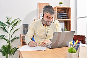 Young hispanic man call center agent working at office