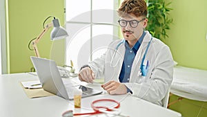 Young hispanic man doctor prescribing pills smiling at street