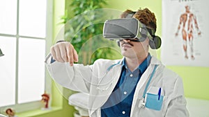 Young hispanic man doctor using virtual reality glasses at the clinic