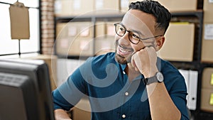 Young hispanic man ecommerce business worker thinking at office