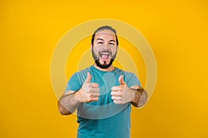 Young hispanic man portrait on yellow background in Mexico Latin America