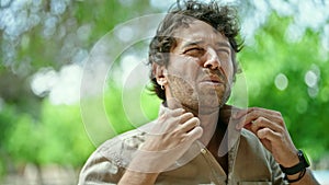 Young hispanic man sweating at park