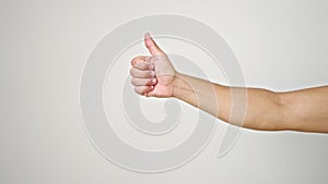 Young hispanic man with thumb up gesture over isolated white background