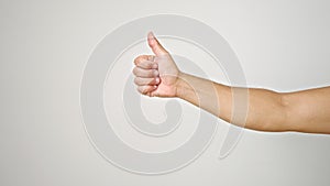 Young hispanic man with thumb up gesture over isolated white background