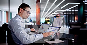 Young Hispanic Man Using Gantt Chart Software