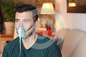 Young Hispanic man using oxygen mask