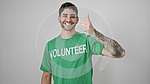 Young hispanic man volunteer doing thumb up smiling over isolated white background