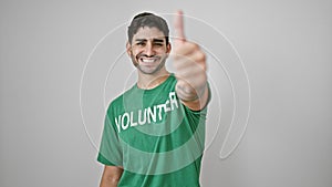 Young hispanic man volunteer doing thumb up smiling over isolated white background