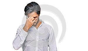 Young hispanic man wearing business shirt and glasses tired rubbing nose and eyes feeling fatigue and headache