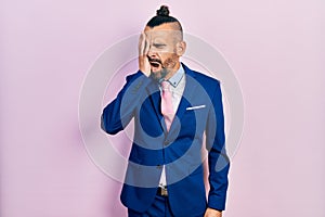 Young hispanic man wearing business suit and tie yawning tired covering half face, eye and mouth with hand