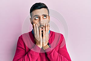 Young hispanic man wearing casual clothes tired hands covering face, depression and sadness, upset and irritated for problem