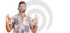 Young hispanic man wearing summer clothes relax and smiling with eyes closed doing meditation gesture with fingers
