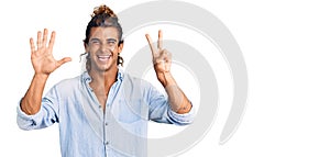 Young hispanic man wearing summer style showing and pointing up with fingers number seven while smiling confident and happy
