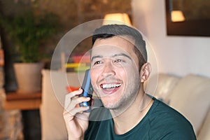 Young hispanic using retro style landline cordless phone