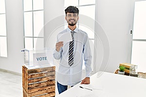 Young hispanic voter man holding vote at electoral college