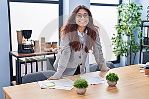 Young hispanic woman business worker smiling confident standing at office