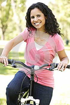 Young Hispanic Woman Cycling In Park