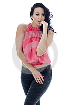 Young Hispanic Woman Nervously Posing In A Pink Top and Black Jeans