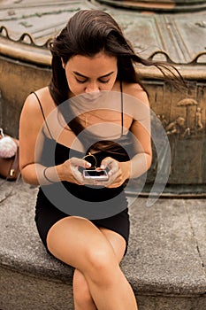 Young Hispanic woman sitting on a bench