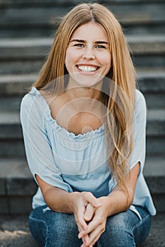 Young hispanic woman smiling on camera outdoor in the city - Focus on face