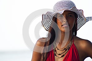 Young Hispanic Woman in Sun Hat at Beach