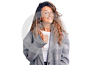 Young hispanic woman with tattoo wearing business oversize jacket doing happy thumbs up gesture with hand