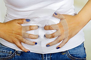 Young hispanic woman touching her belly, suffering menstrual period pain, female health concept