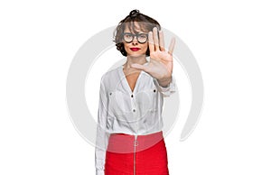 Young hispanic woman wearing business style and glasses doing stop sing with palm of the hand