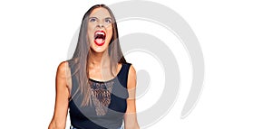Young hispanic woman wearing casual clothes angry and mad screaming frustrated and furious, shouting with anger
