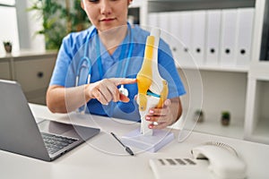 Young hispanic woman wearing doctor uniform having teleconsultation at clinic