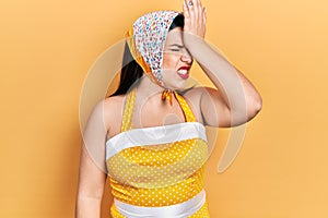 Young hispanic woman wearing pin up style surprised with hand on head for mistake, remember error