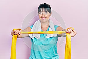 Young hispanic woman wearing sportswear and arm band smiling with a happy and cool smile on face