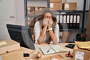 Young hispanic woman working at small business ecommerce rubbing eyes for fatigue and headache, sleepy and tired expression