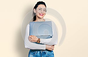 Young hispanic woman working using computer laptop smiling with a happy and cool smile on face