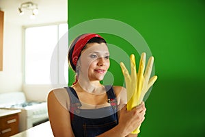 Young Hispanic Woman With Yellow Latex Gloves Cleaning Home