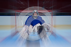 Young hockey goalie and flying puck